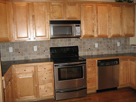 Kitchen with awesome backsplash and S/S appliances!