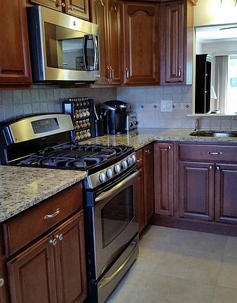 Kitchen in new cond, granite counter S steel appliances with maple cabinets