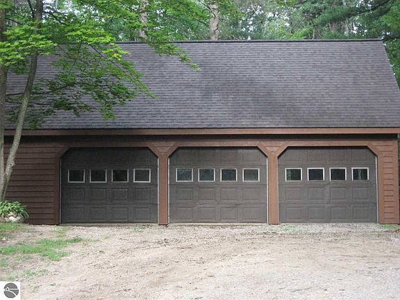 Detached 3 car garage with unfinished loft above.