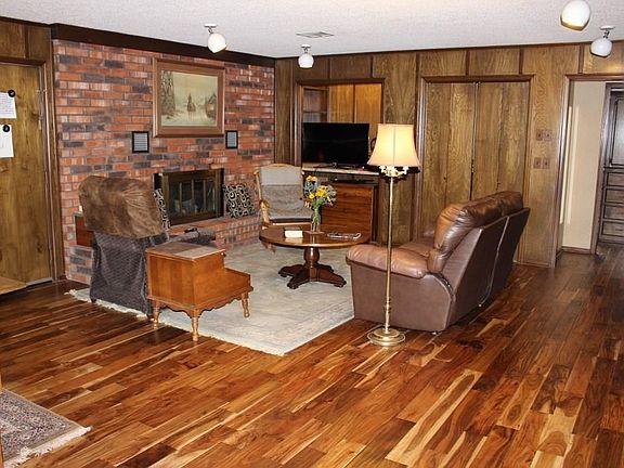 Family room with built in bookcases, fireplace with gas logs, wet bar and wood floors.
