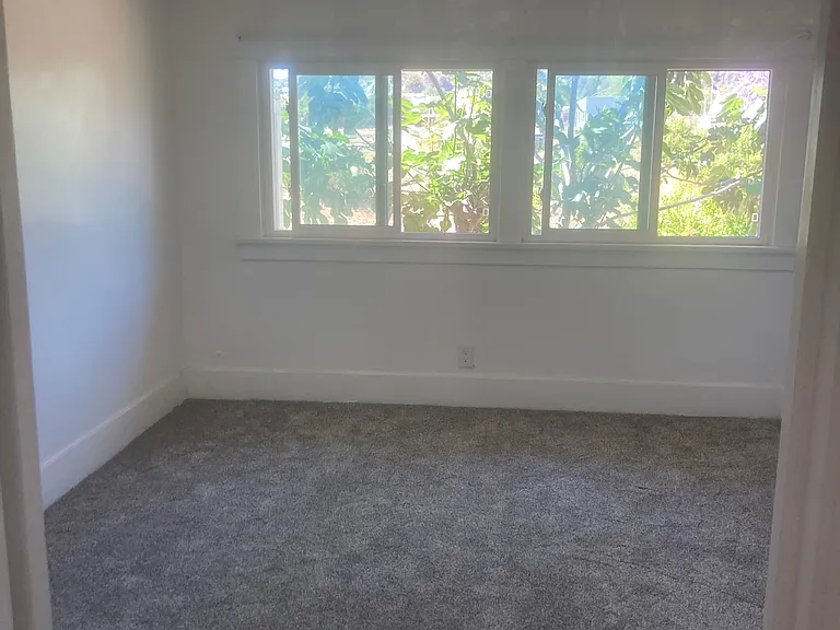 The second bedroom is off the kitchen, has recently installed carper, a small walk-in carpet. It has a view of the orchard, stream and mountains