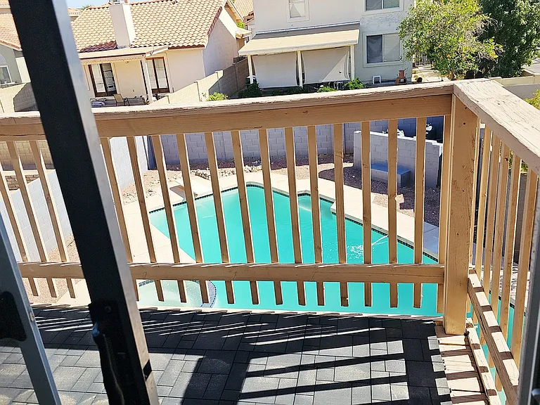 Private balcony off the primary suite overlooking the backyard pool, perfect for relaxing and enjoying the view.