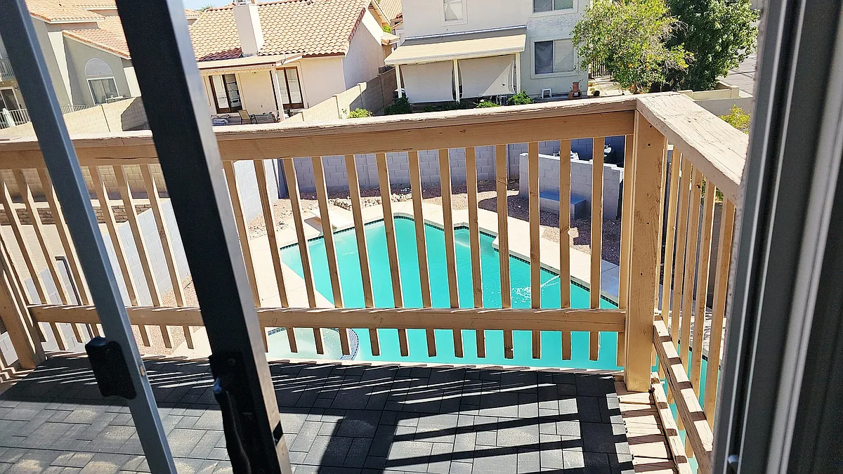 Private balcony off the primary suite overlooking the backyard pool, perfect for relaxing and enjoying the view. - 19403 N 78th Ave