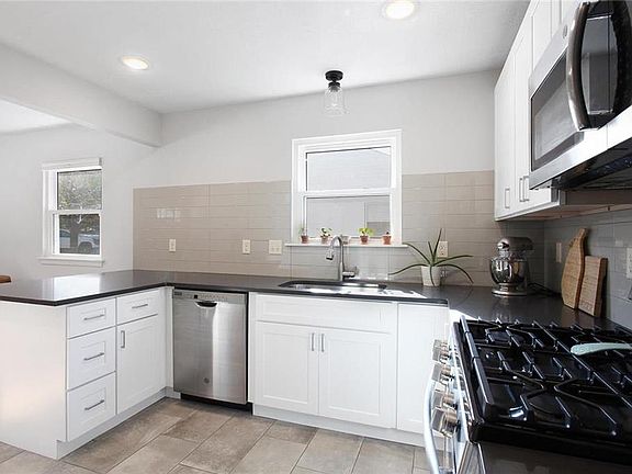 Gas range, great subway tile - this kitchen is new and perfect.