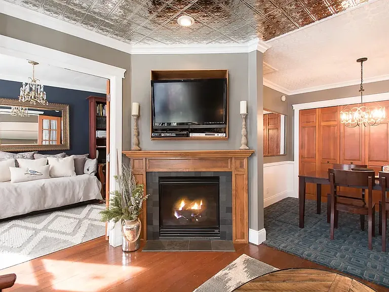 Living room fireplace with library to left and dining room to right.