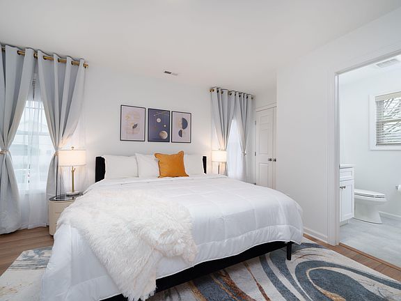 Primary bedroom upstairs with a view of the private ensuite bathroom