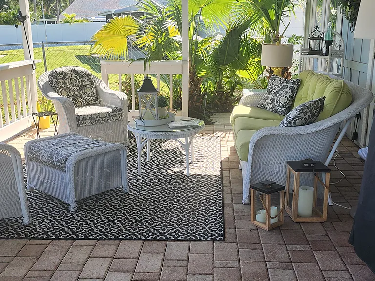 Outdoor patio area, couch and two very comfortable chairs. Beautifully lit at night (On remote). Extra lamps for reading. Super cozy with extra seating stored in the garage.