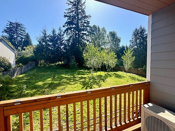 Deck overlooks private greenbelt.