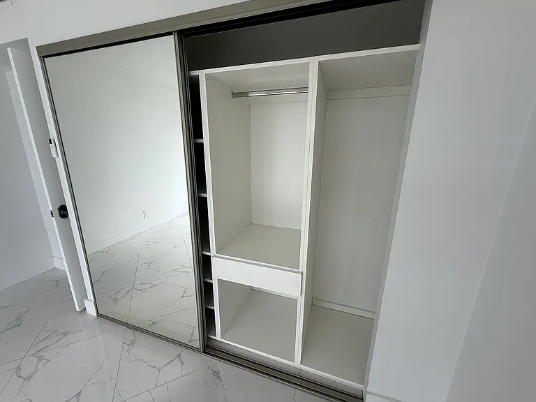 GUEST BEDROOM or OFFICE with dimmable designer lighting, full wall mirror, floor-to-ceiling impact windows, electric blackout curtain, zebra shades & large closet system