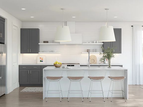 Kitchen with pendant lighting and waterfall island