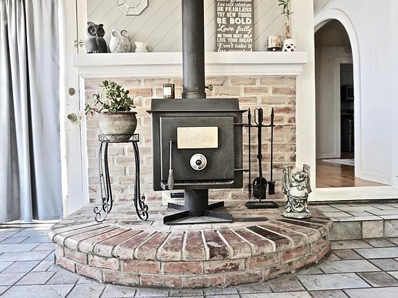 Wood Burning Stove Anchors Focal View of the Sunroom.
