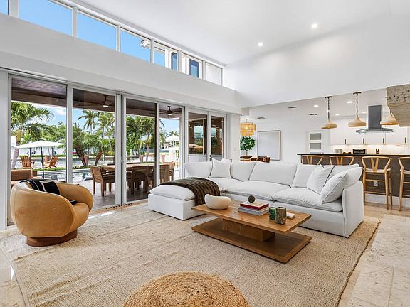 Spacious living area with floor-to-ceiling glass, offering a blend of comfort and elegance with stunning water views.