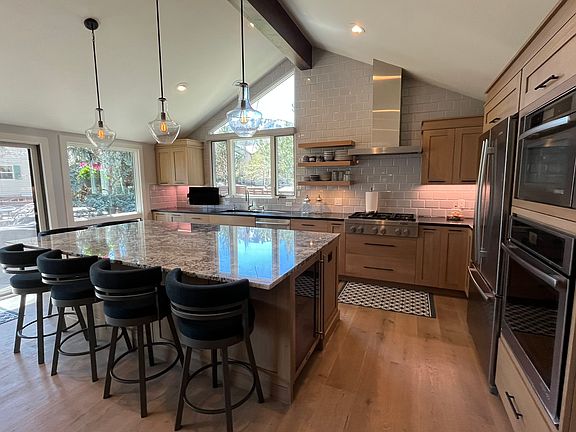 Open shelving, 6 burner gas cooktop, steam oven, European convection oven, separate beverage fridge.