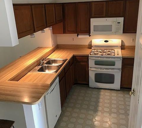 Kitchen with countertop/bar area. Double oven gas stove. Microwave.