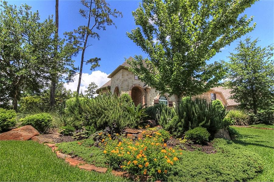 Lush landscaping is mature and easy-care Texas plantings that have helped create an inviting atmosph