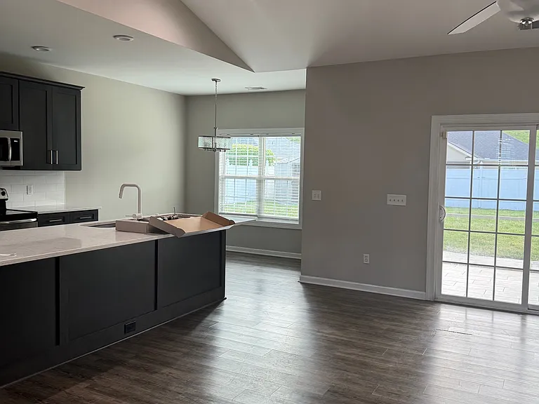 standing at front door looking toward kitchen and toward breakfast area through living room.