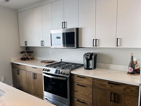 Kitchen with stainless steel GE wifi appliances.