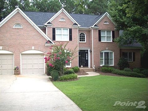 Front of 3 sided brick home