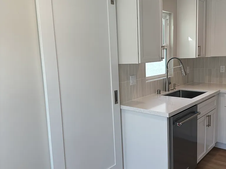 Barn door that leads into the laundry room from the kitchen