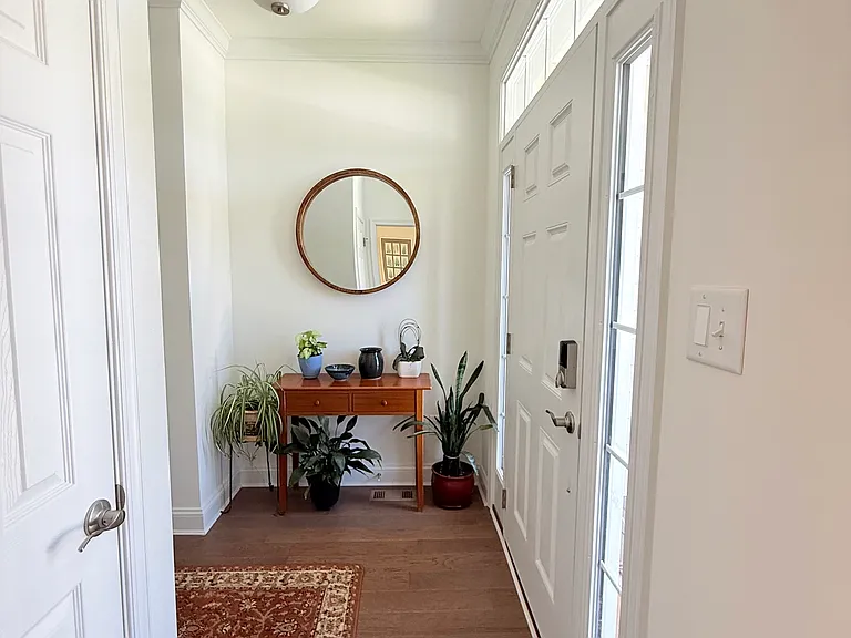 Entryway featuring a half bathroom and coat closet
