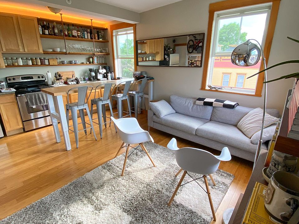 Open floor plan, with lovely light from large windows and glass balcony door.