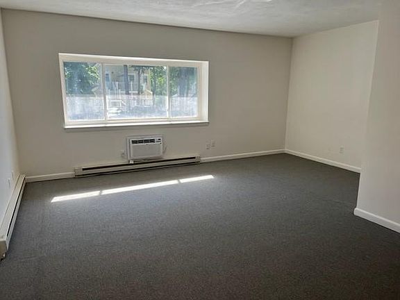 living room with A/C window facing parking lot
