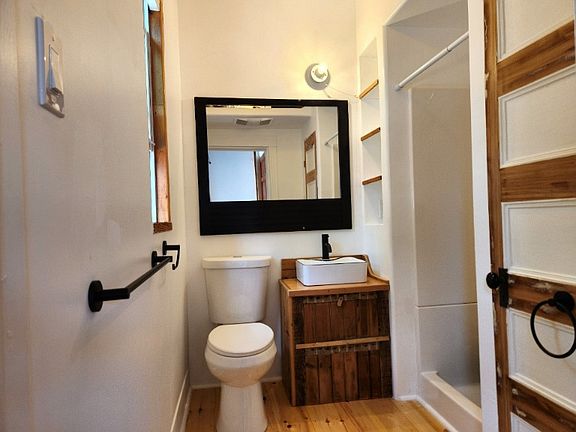 Downstairs bathroom with shower and linen closet.