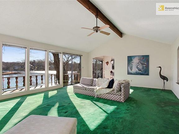 Alternate view of the living room with glimpses of the deck and lake.