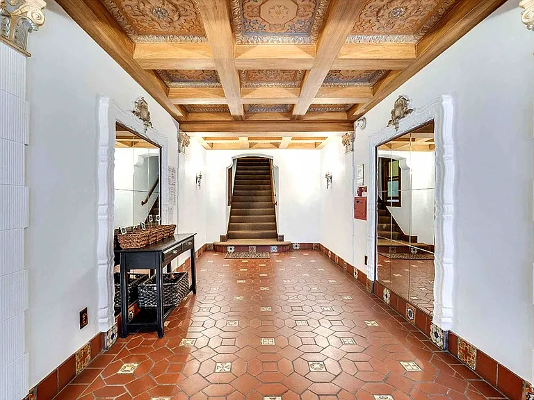 Hallway with a staircase with a wooden banister