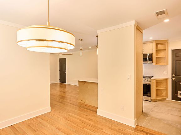 View of the dinning room area showing the front and backdoor of the unit.