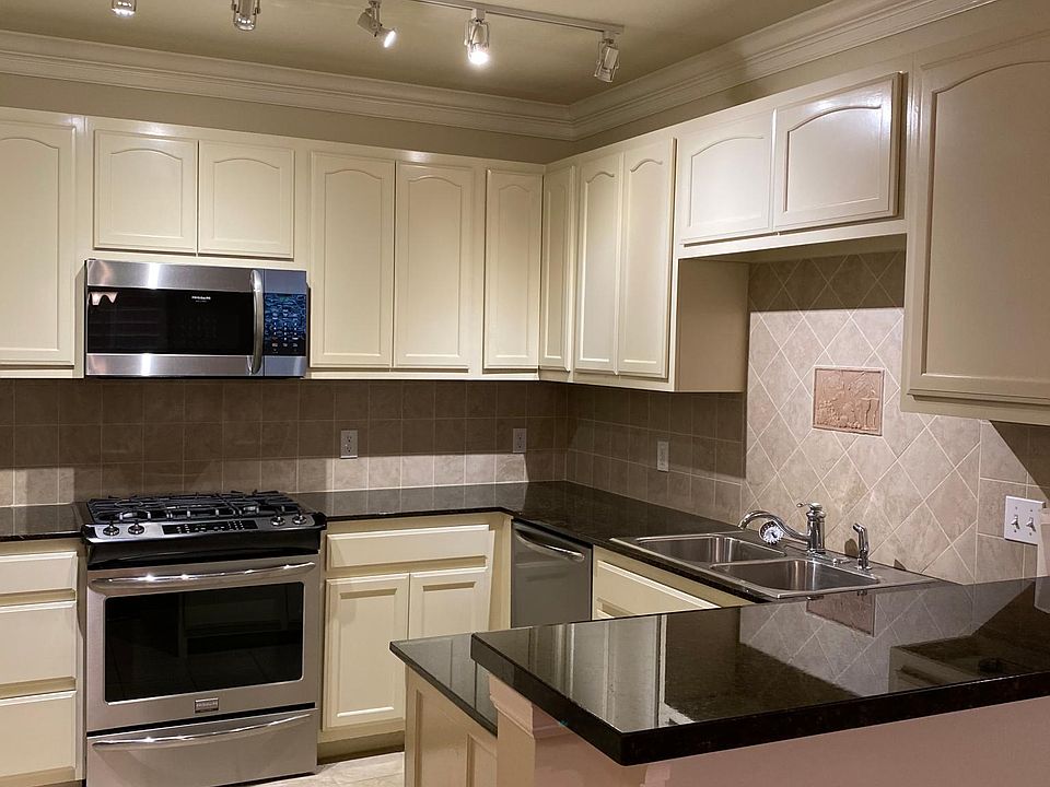Kitchen with granite counter top and stainless steel appliances.