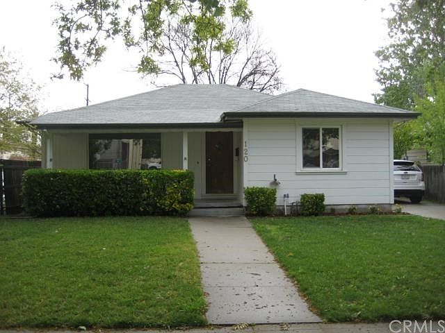 Front of Main House (house faces west) with driveway and carport on the south side of house
