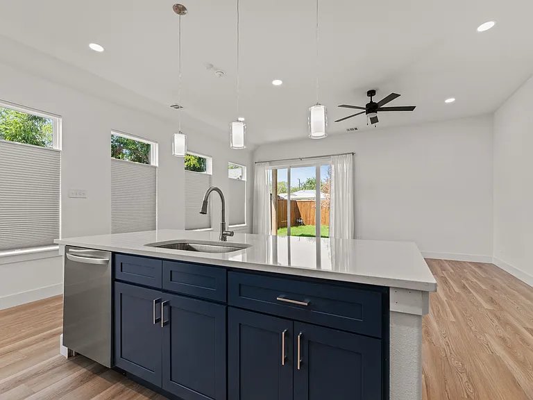 The kitchen island is 8 ft long and has electrical outlets on three sides.