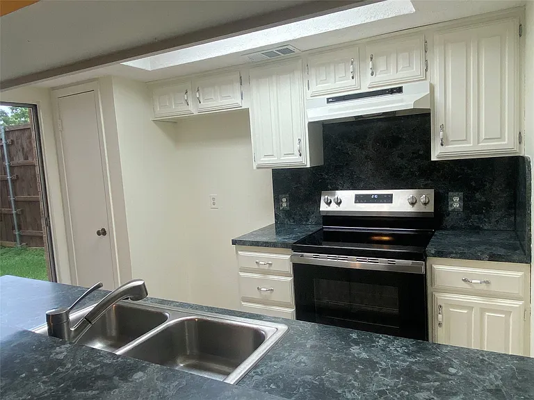 Kitchen has a pantry at far left.