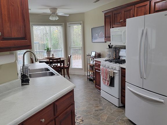 Kitchen includes all appliances, including disposal and dishwasher. Gas stove. Plenty of cupboard space plus pantry closet next to refrigerator. Eat-in area located facing back deck.