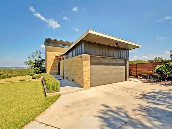 Side-entry garage, plenty of surface parking as well. Gorgeous privacy fence encloses beautiful, level lawn in back.