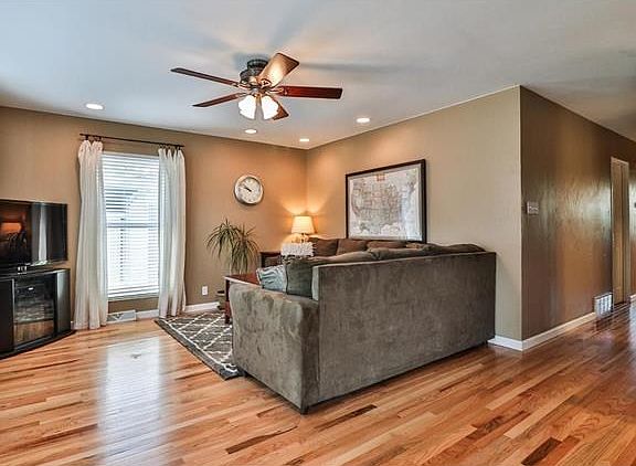 Large open living room with gorgeous new hardwood floors and baseboards that were installed in 2015