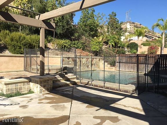 Backyard with patio and optional pool fence.