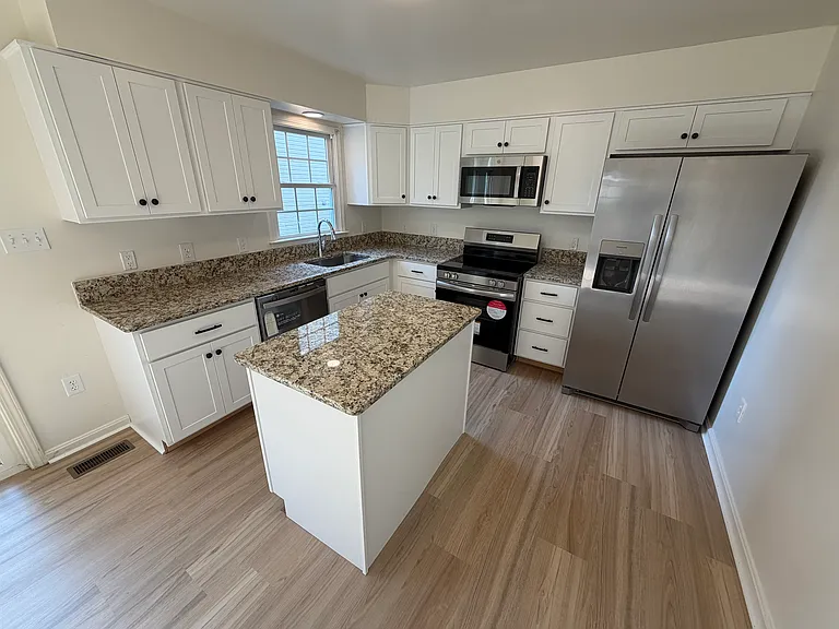 Spectacular kitchen with new cabinets, granite countertops, stainless steel appliances, and luxury vinyl floor