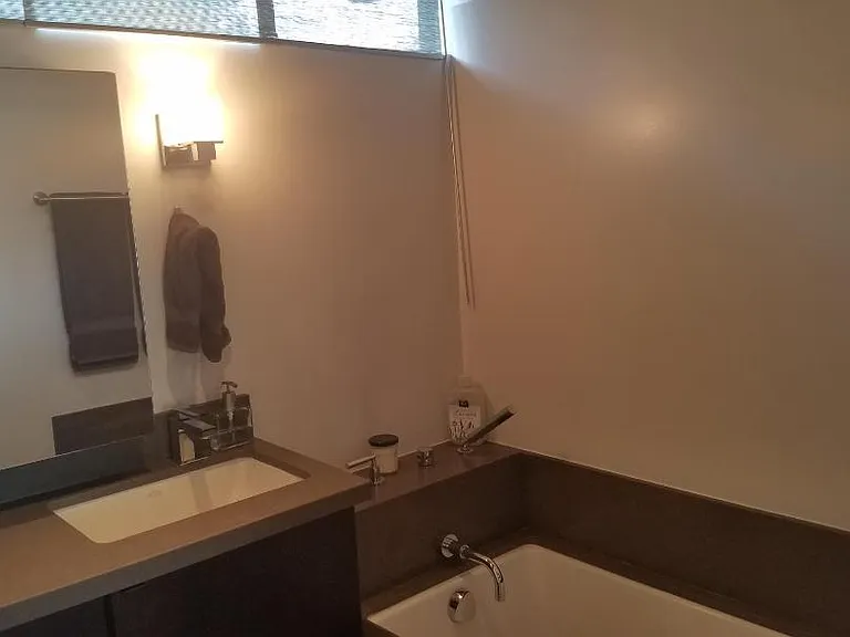 Remodeled bathroom featuring dual vanities, a deep soaking tub, and a separate shower.