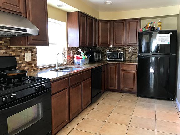 Kitchen with 3 shared refrigerators