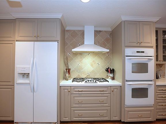 The crown molding has been carried into the kitchen, accenting the many cabinets and back splash.