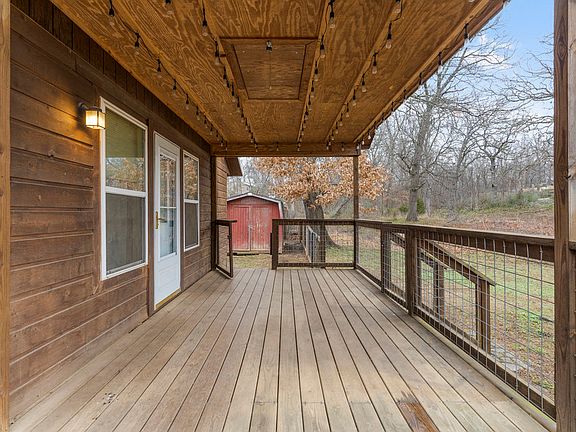 Back yard entrance from side porch and small storage shed.