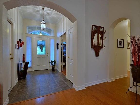 The foyer has hard tile flooring and crown molding and upon entry, you will immediately notice the r