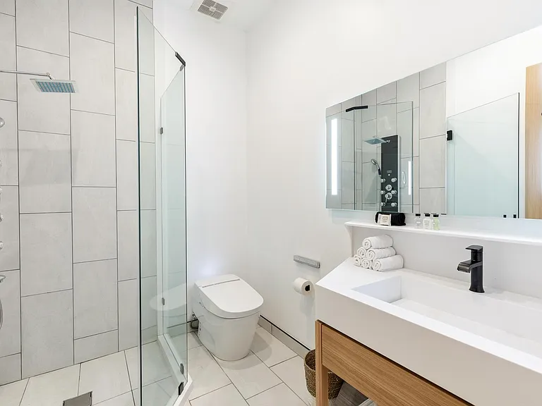 LED lit vanity mirrors, Toto Neorest toilet and graft rain shower.