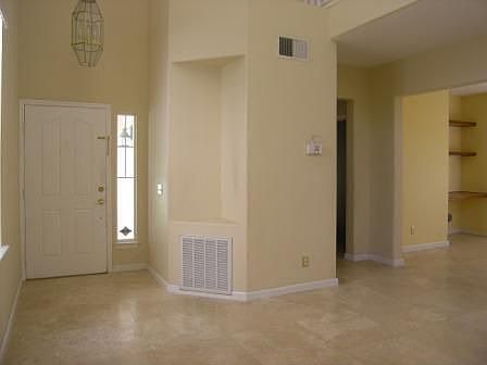 Entry to this residence features high ceilings & tile flooring 