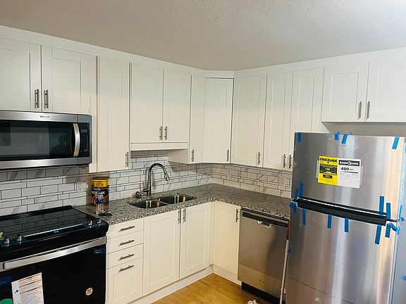 Kitchen includes refrigerator, stove, dishwasher, microwave.