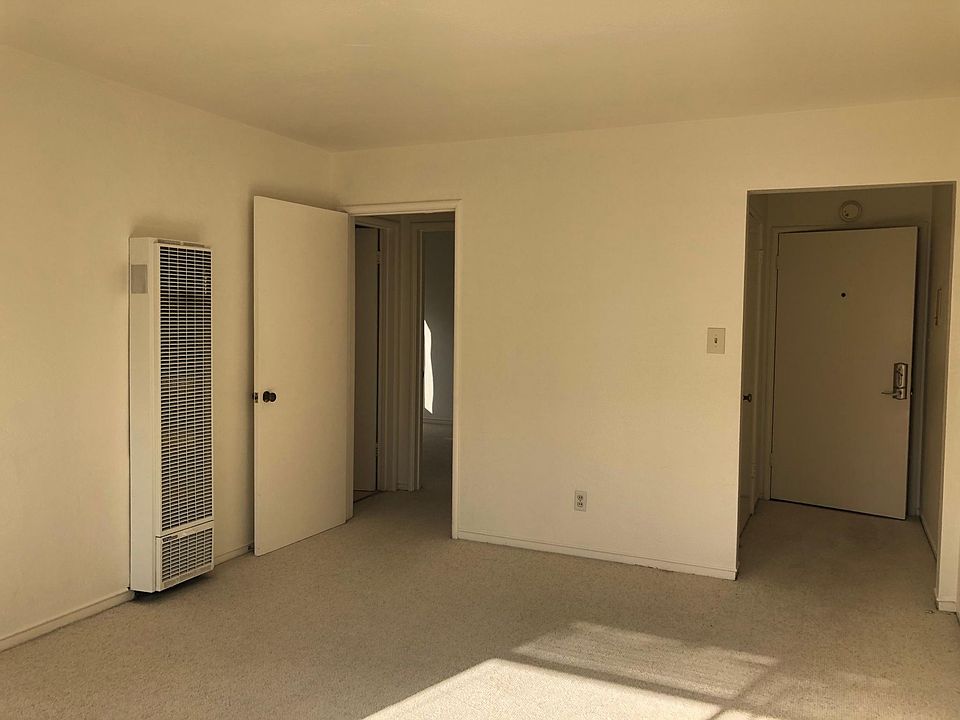 In living room, looking toward bed/bath hall (on left) and entry (on right).