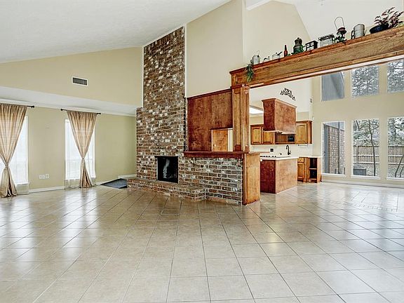 Looking from the den into the dining area and kitchen