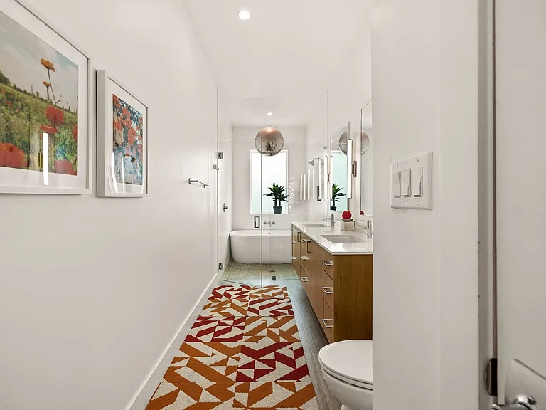 Bathroom featuring a freestanding soaking tub, dual vanity with undermount sinks, and a glass-enclosed shower